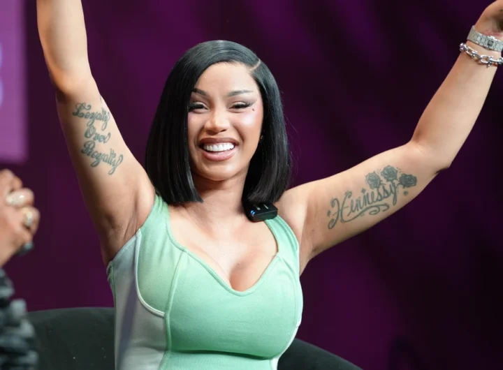Cardi B performing with both arms raised at the 2026 Essence Festival of Culture