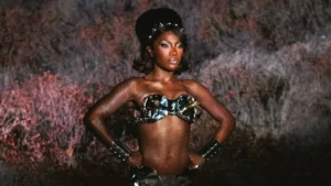 Doechii in a metallic fembot costume from the Bombs Swamp Sessions visual